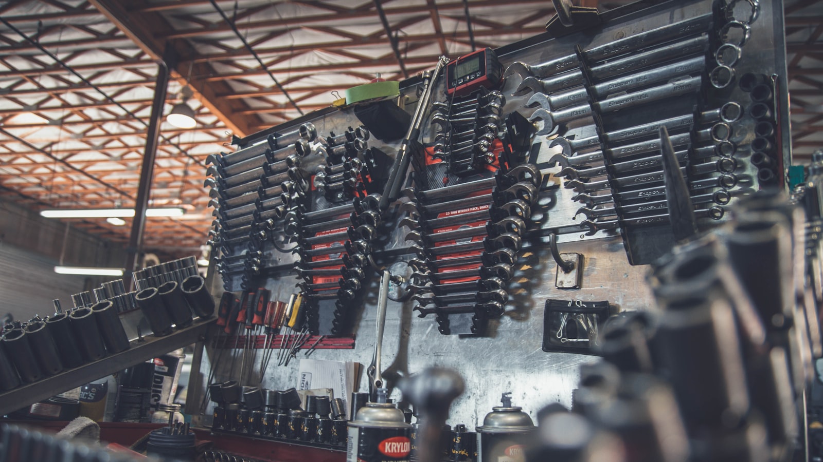 Fresh engine oil being poured into a car engine through a funnel.