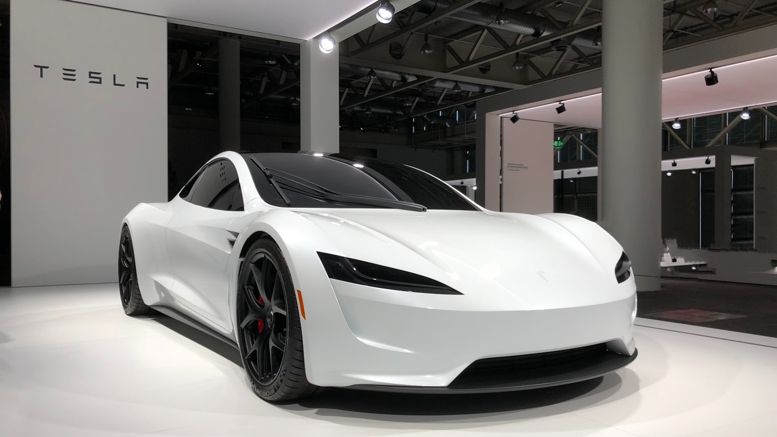 An electric car parked in a home driveway with the charge port door open